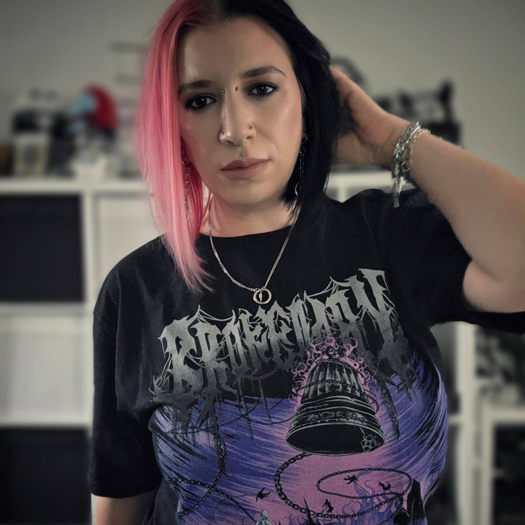 Person wearing a black t-shirt with a graphic design, indoors.