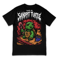 A black short-sleeve graphic t-shirt featuring a cartoon green turtle in a sandbox holding a shovel, with the text 'THIS IS SANDPIT TURTLE' in a distressed white font above it.