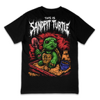 A black short-sleeve graphic t-shirt featuring a cartoon green turtle in a sandbox holding a shovel, with the text 'THIS IS SANDPIT TURTLE' in a distressed white font above it.